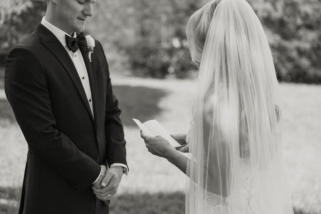 bride and groom exchanging vows during first looks 