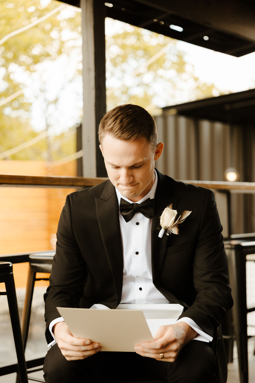 groom getting ready for black and white themed wedding